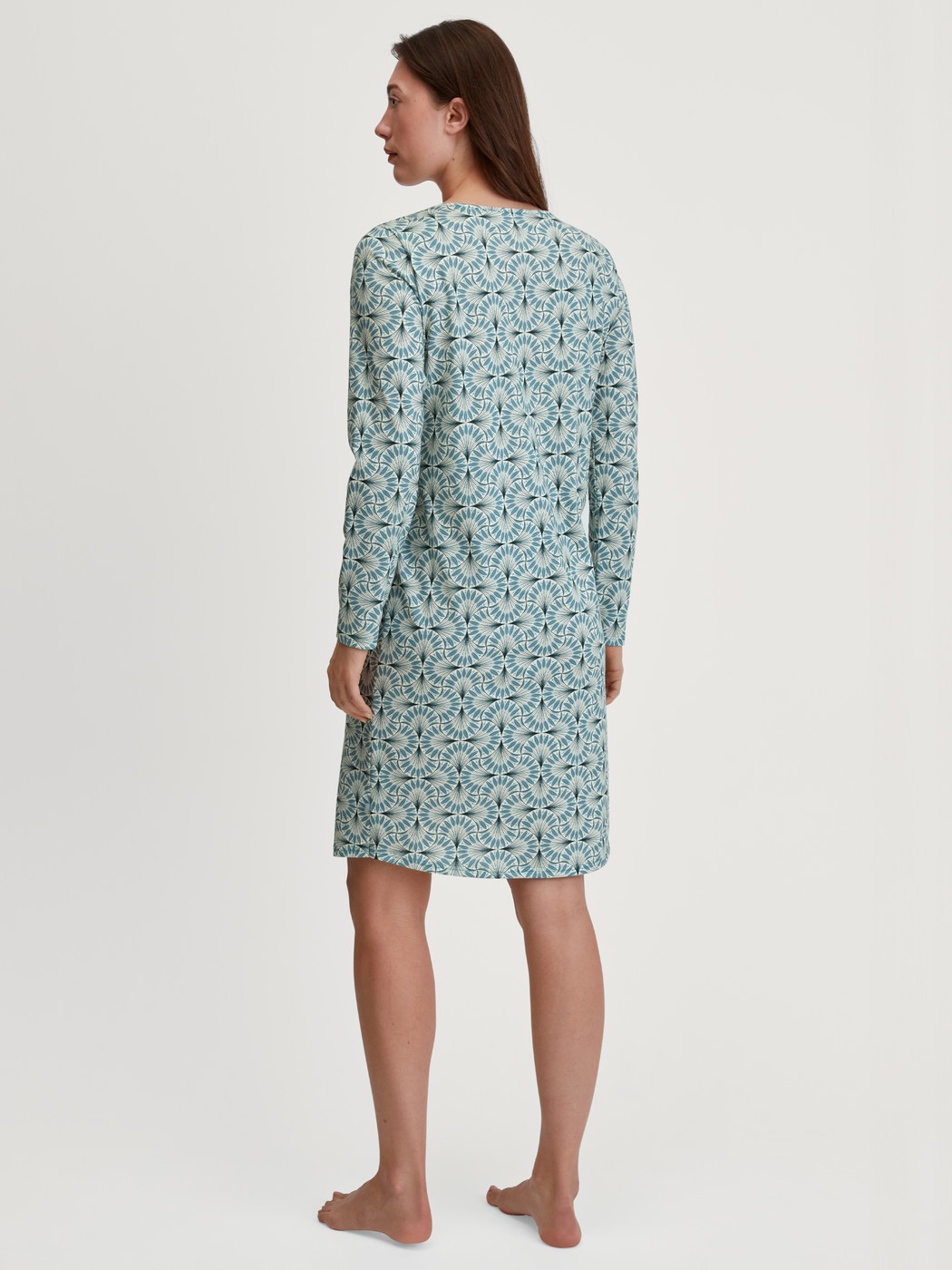 Women model is wearing Long Sleeve Nightdress – 100 cm Length made of 100% Cotton in Blue, Patterned from the Ornament Nights series by CALIDA, Back view