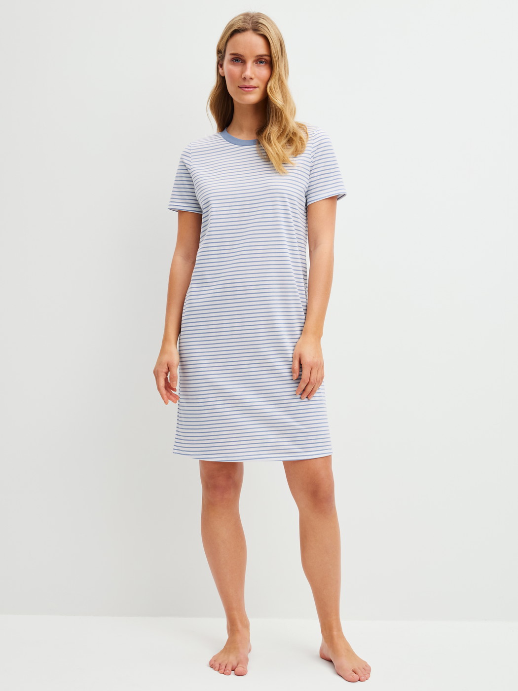 Women model is wearing Short-sleeved nightdress, length 95 cm made of 100% Cotton in Blue, Striped from the Cotton Special series by CALIDA, Front view