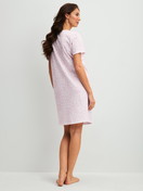 Women model is wearing Sleepshirt, length 95cm made of 100% Cotton in Purple, Patterned from the Blooming Nights series by CALIDA, Back view