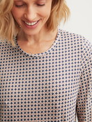 Women model is wearing Long-sleeve nightdress, length 100 cm made of 100% Cotton in Blue, Patterned from the Graphic Nights series by CALIDA, Detail