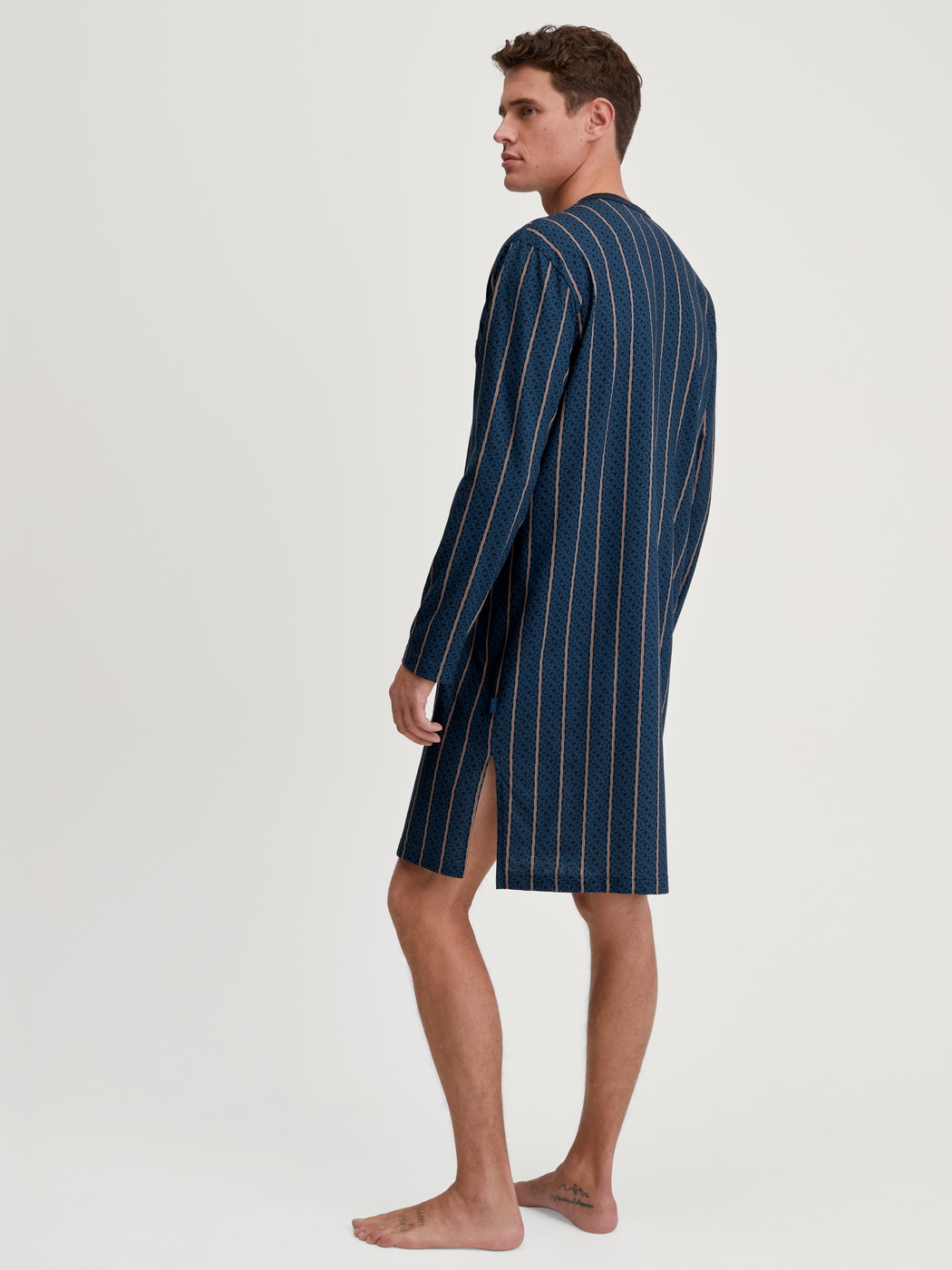 Men model is wearing Nightshirt made of 100% Cotton in Blue, Striped from the Relax Imprint 1 series by CALIDA, Back view