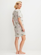 Women model is wearing Short-sleeved nightdress, length 95 cm made of 100% Cotton in Green, Floral from the Leaf Dreams series by CALIDA, Back view