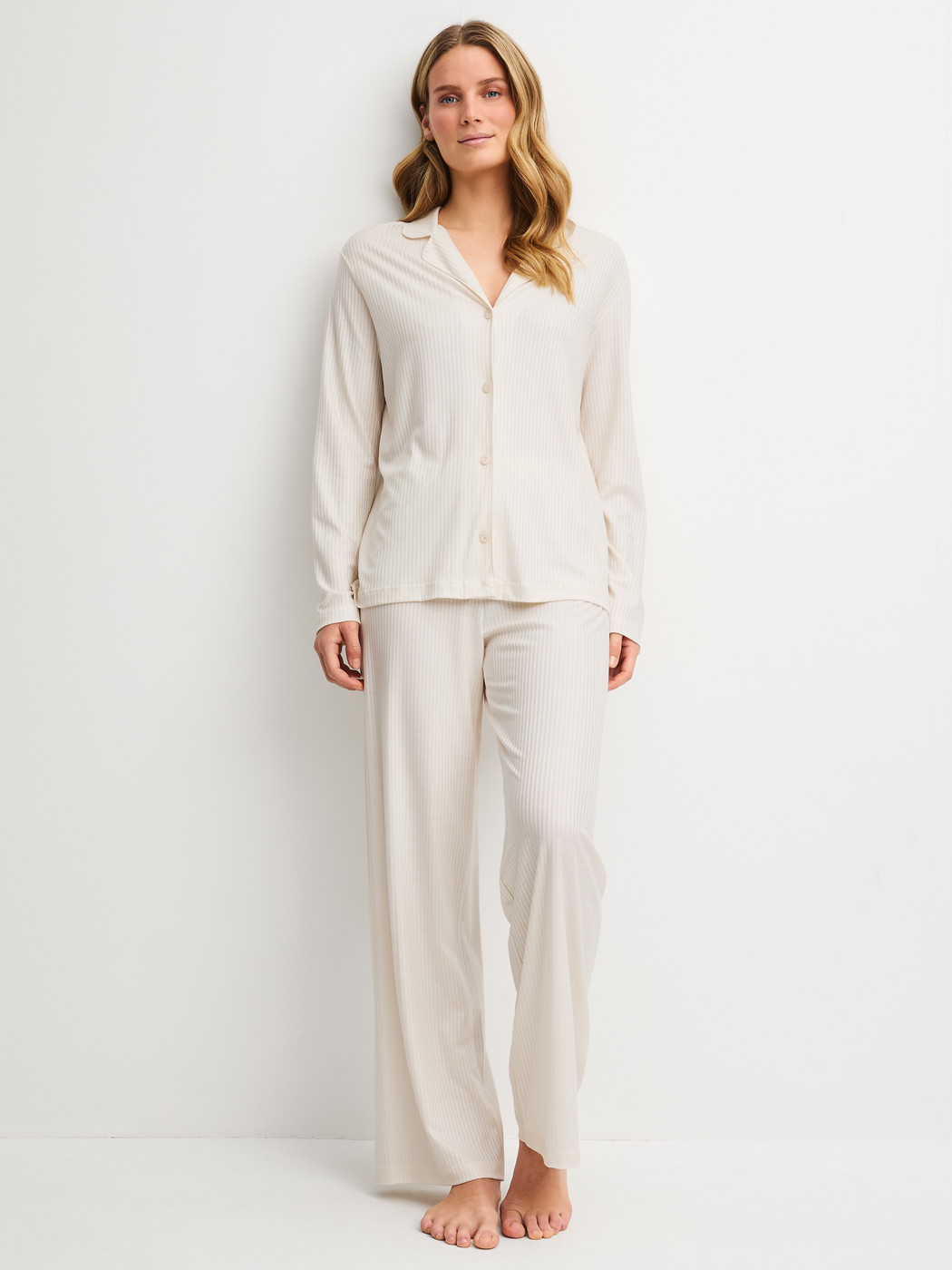 Women model is wearing Pyjamas with buttons made of Modal in Beige, Striped from the Striped Dreams series by CALIDA, Front view