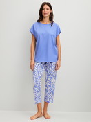 Women model is wearing 7/8 - Pyjamas made of 100% Cotton in Blue, Floral from the Cotton Special series by CALIDA, Front view
