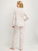 Women model is wearing Button-Up Pyjama made of 100% Cotton in Pink, Floral from the Cotton Special series by CALIDA, Back view