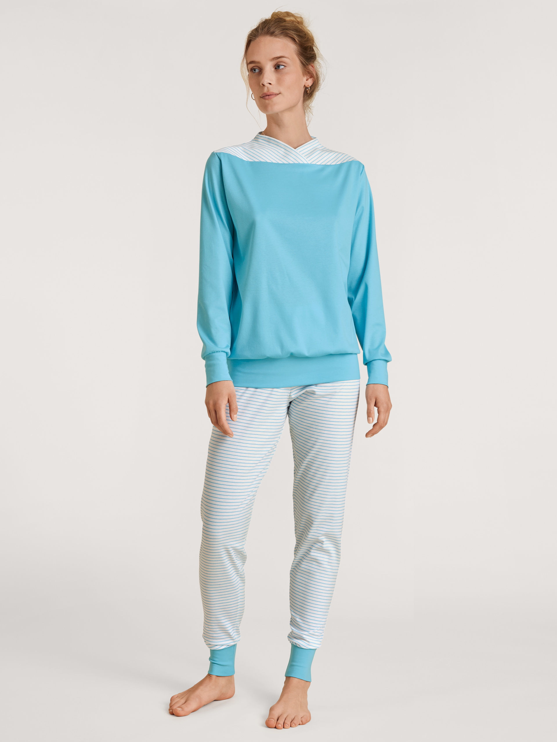 Women model is wearing Pyjama with cuff made of 100% Cotton in Turquoise, Striped from the Soulmate series by CALIDA, Front view