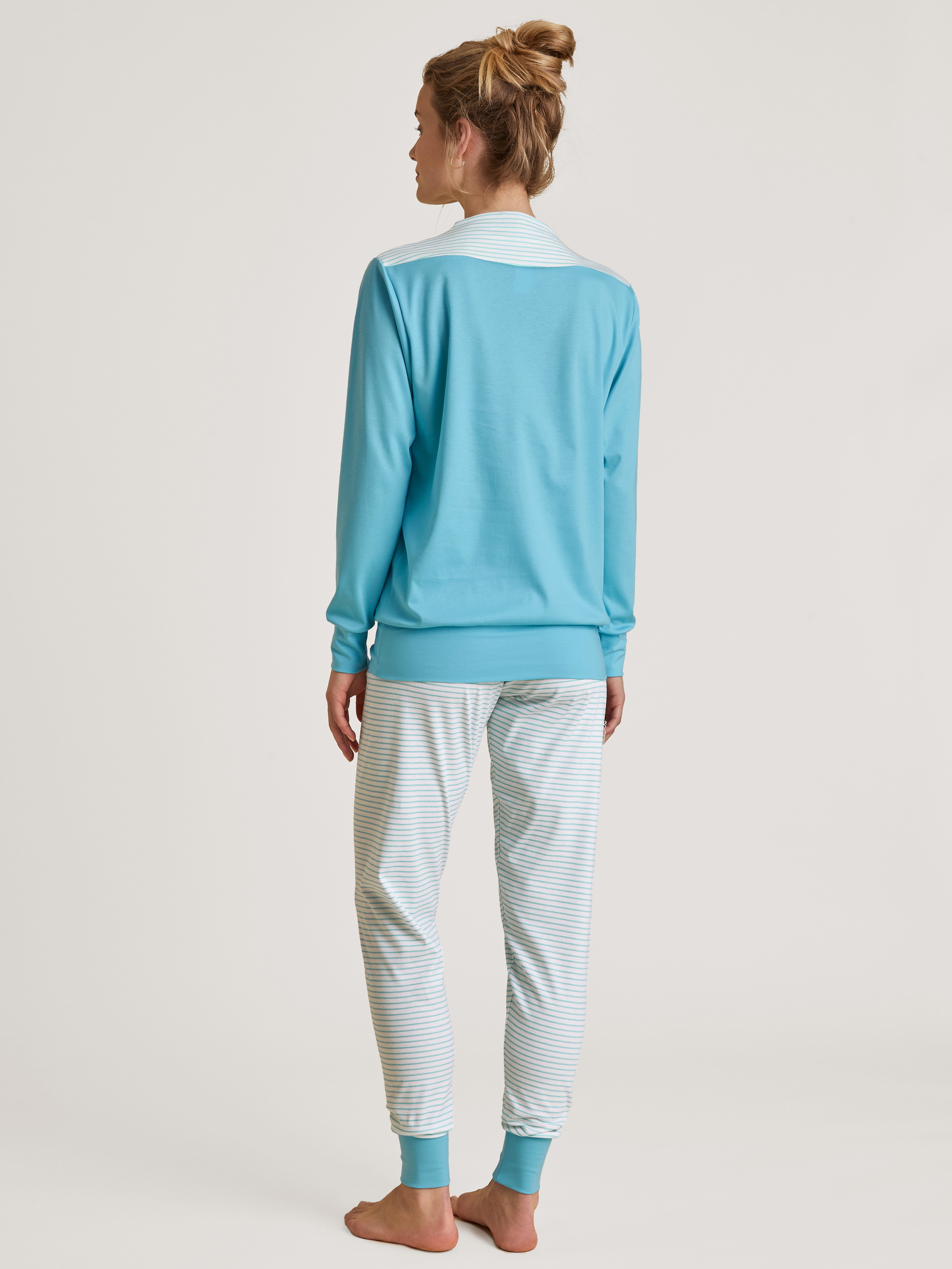 Women model is wearing Pyjama with cuff made of 100% Cotton in Turquoise, Striped from the Soulmate series by CALIDA, Back view