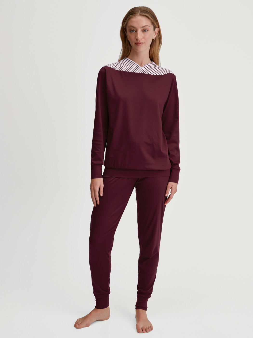 Women model is wearing Pyjama with cuff made of 100% Cotton in Red, Patterned from the Season Special series by CALIDA, Front view