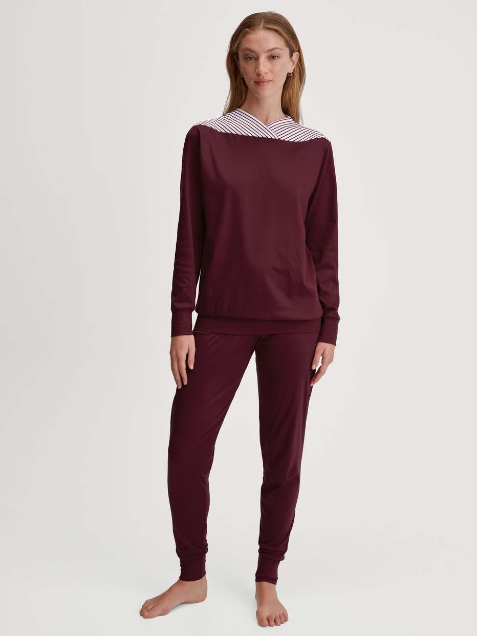 Women model is wearing Pyjama with cuff made of 100% Cotton in Red, Patterned from the Season Special series by CALIDA, Front view