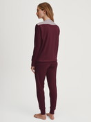 Women model is wearing Pyjama with cuff made of 100% Cotton in Red, Patterned from the Season Special series by CALIDA, Back view