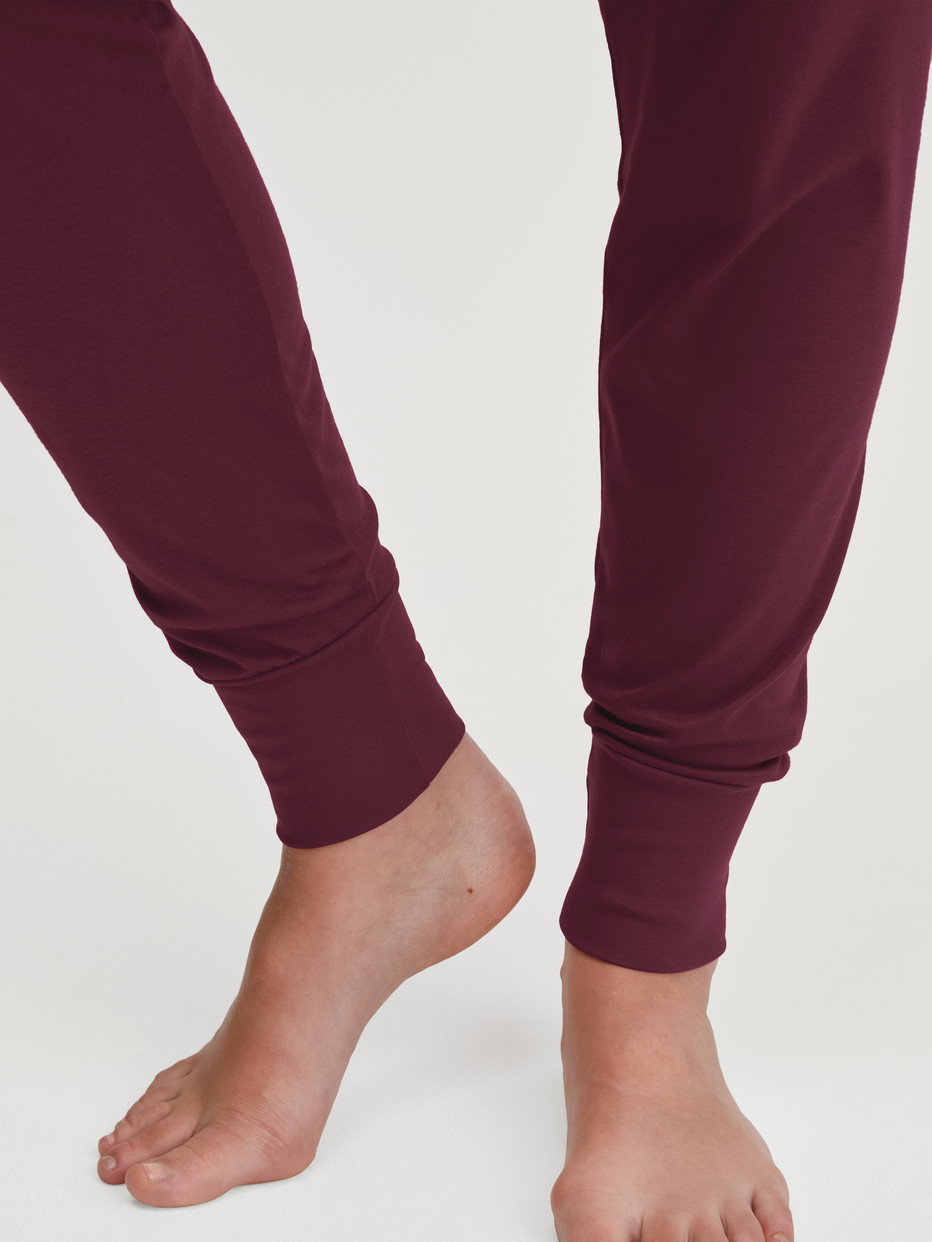 Women model is wearing Pyjama with cuff made of 100% Cotton in Red, Patterned from the Season Special series by CALIDA, Detail