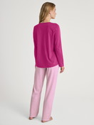 Women model is wearing Pyjamas, long made of 100% Cotton in Red, Patterned from the Cotton Special series by CALIDA, Back view