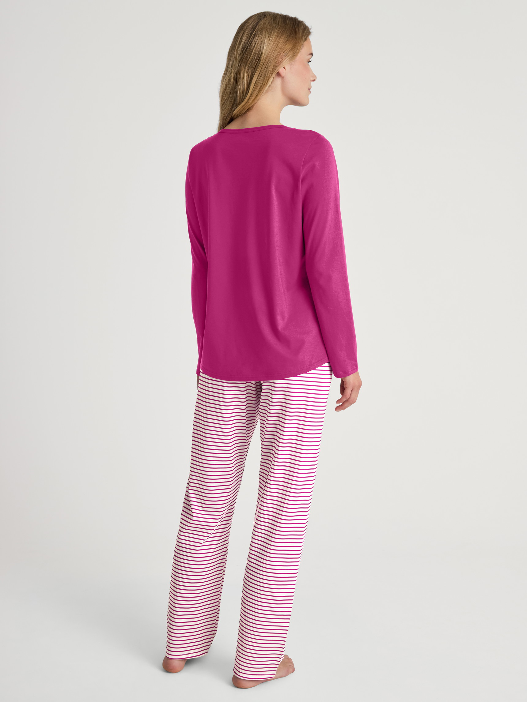 Women model is wearing Pyjamas, long made of 100% Cotton in Red, Patterned from the Cotton Special series by CALIDA, Back view
