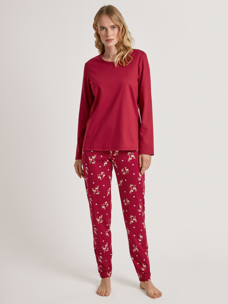 Women model is wearing Pyjamas, long made of 100% Cotton in Red, Motif from the Family & Friends series by CALIDA, Front view