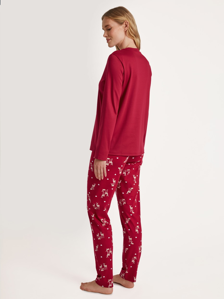 Women model is wearing Pyjamas, long made of 100% Cotton in Red, Motif from the Family & Friends series by CALIDA, Back view