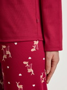 Women model is wearing Pyjamas, long made of 100% Cotton in Red, Motif from the Family & Friends series by CALIDA