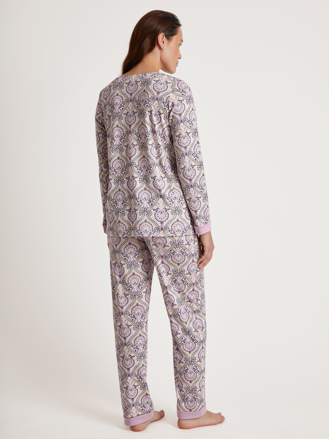 Women model is wearing Pyjama made of 100% Cotton in Purple, Floral from the Orient Dreams series by CALIDA, Back view
