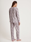Women model is wearing Pyjama made of 100% Cotton in Purple, Floral from the Orient Dreams series by CALIDA, Back view