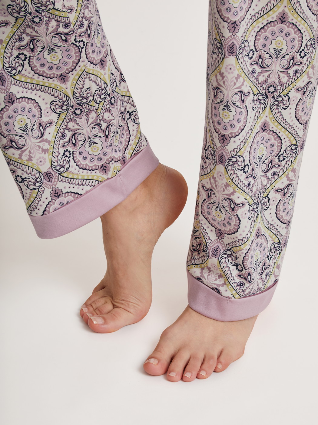 Women model is wearing Pyjama made of 100% Cotton in Purple, Floral from the Orient Dreams series by CALIDA