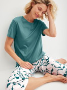 Damen-Model trägt Kurz-Pyjama aus 100% Baumwolle in Türkis, Floral aus Serie Botanic Dreams von CALIDA, Zusatzbild