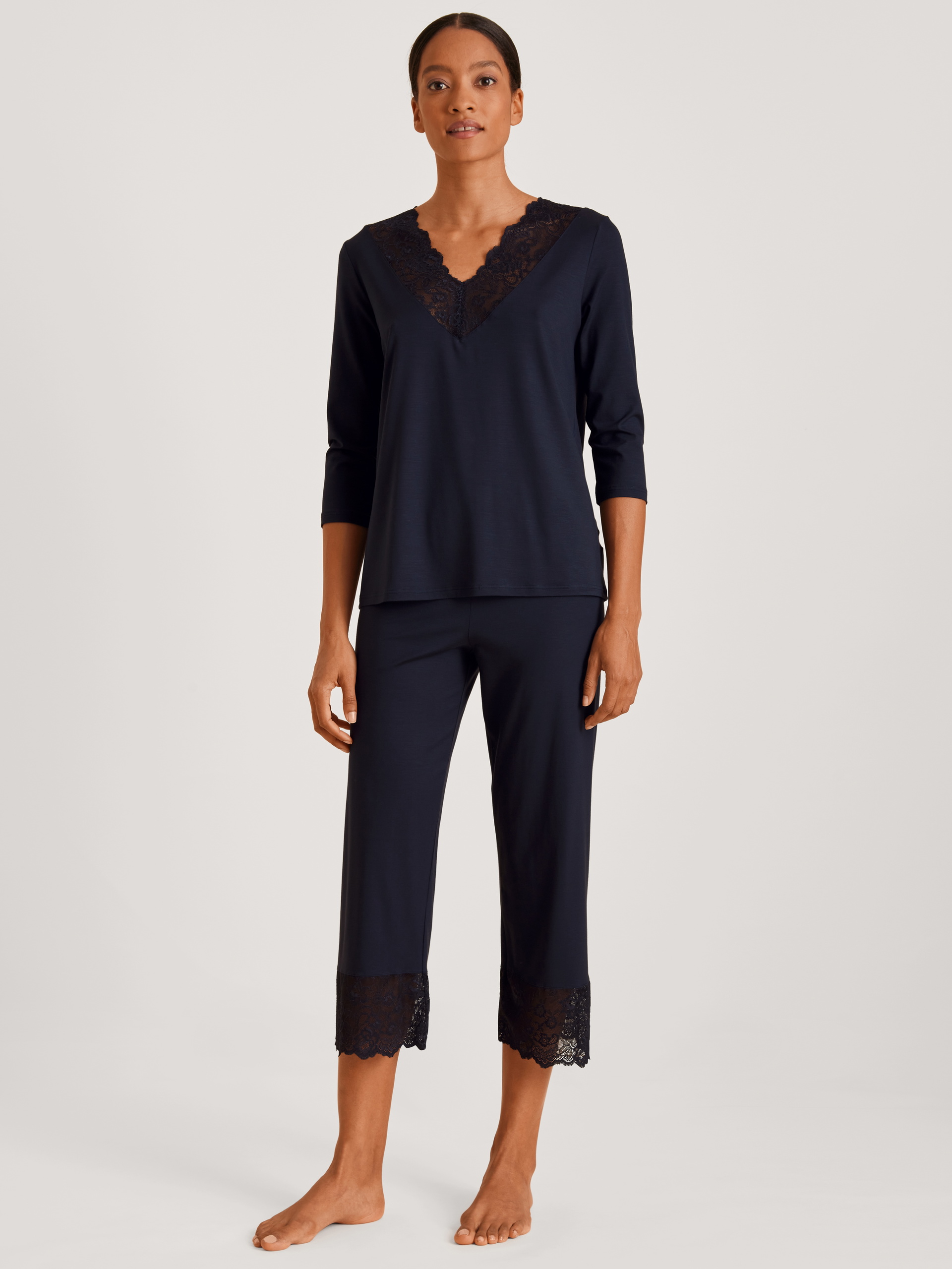 Women model is wearing 7/8 pyjama made of Modal in Blue, Lace from the Elegant Dreams series by CALIDA, Front view