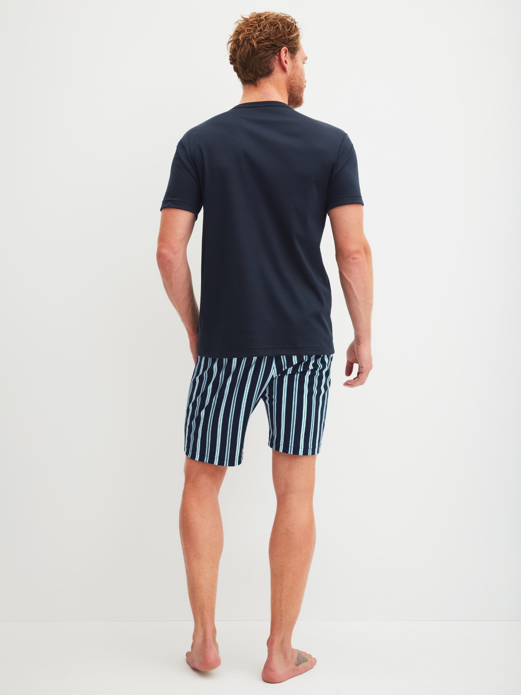 Men model is wearing Short pyjama made of 100% Cotton in Blue, Striped from the Relax Choice series by CALIDA, Back view