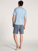 Men model is wearing Short pyjama made of 100% Cotton in Blue, Motif from the Relax Choice series by CALIDA, Back view