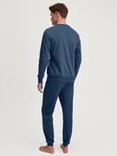 Men model is wearing Pyjama with cuff made of 100% Cotton in Blue, Motif from the Relax Ski Resort series by CALIDA, Back view