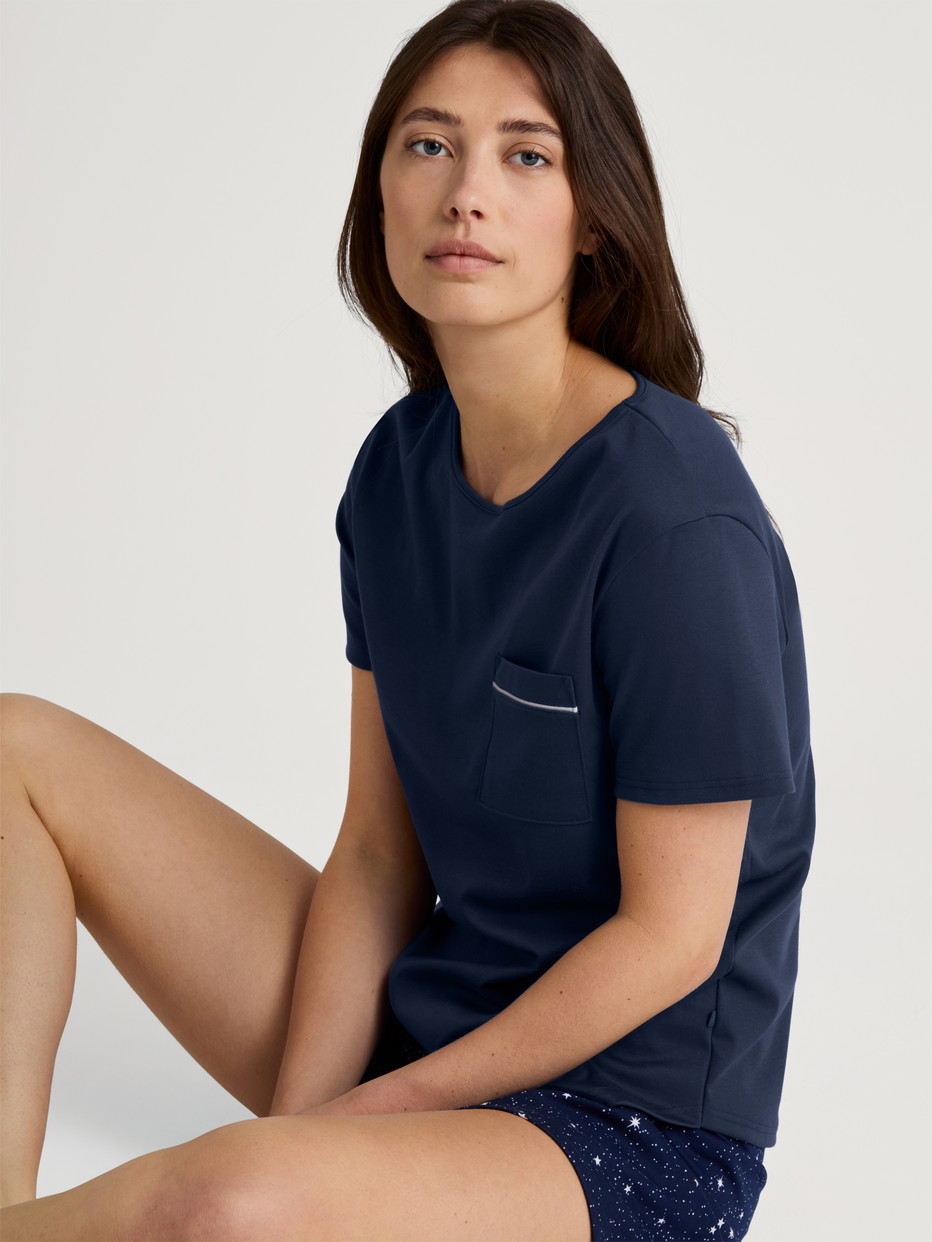 Women model is wearing Short pyjama made of 100% Cotton in Blue, Patterned from the Sweet Dreams series by CALIDA, Front view