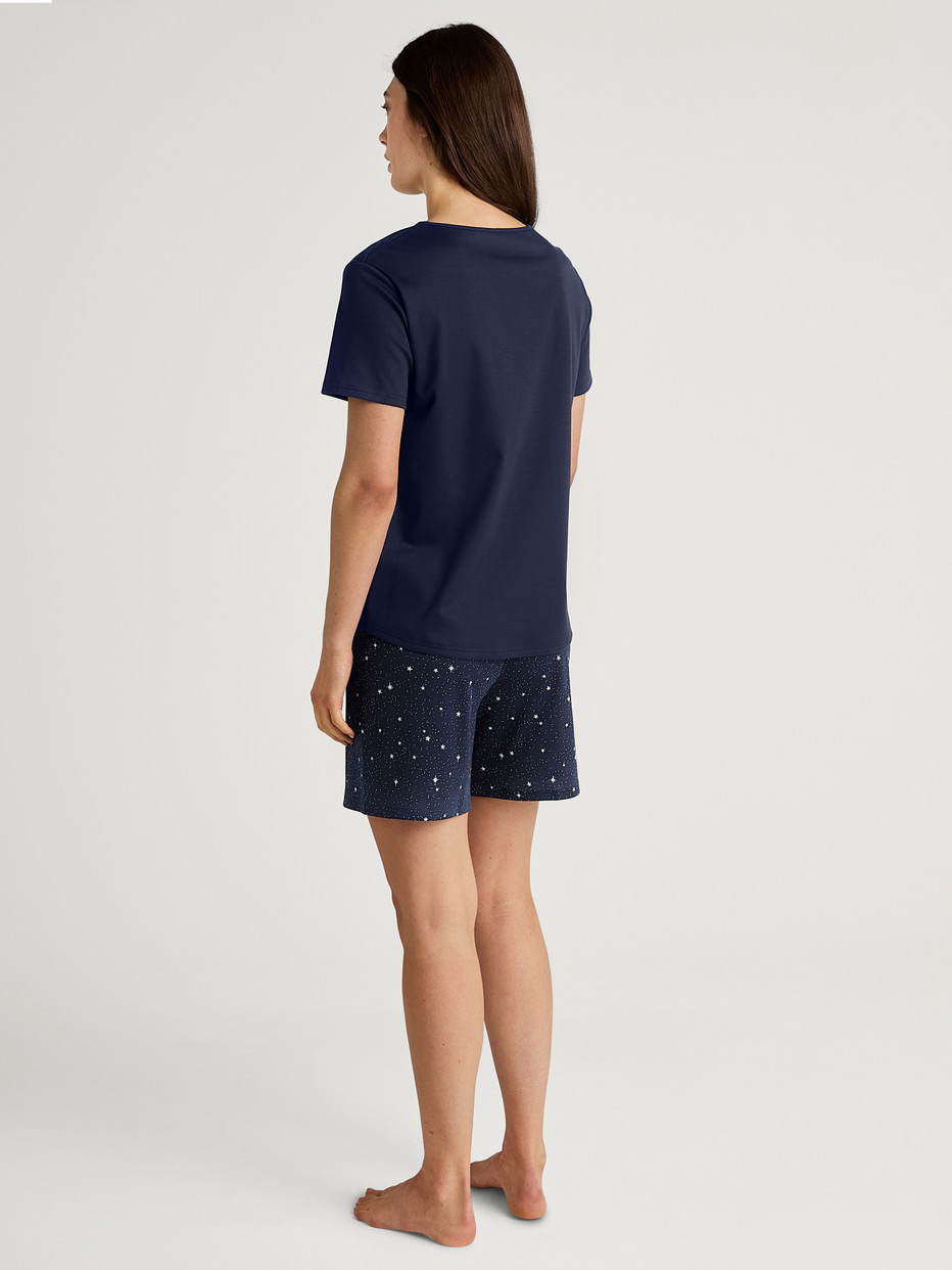 Women model is wearing Short pyjama made of 100% Cotton in Blue, Patterned from the Sweet Dreams series by CALIDA, Back view