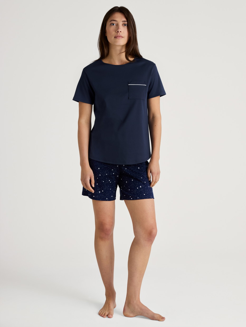 Women model is wearing Short pyjama made of 100% Cotton in Blue, Patterned from the Sweet Dreams series by CALIDA, Outfit