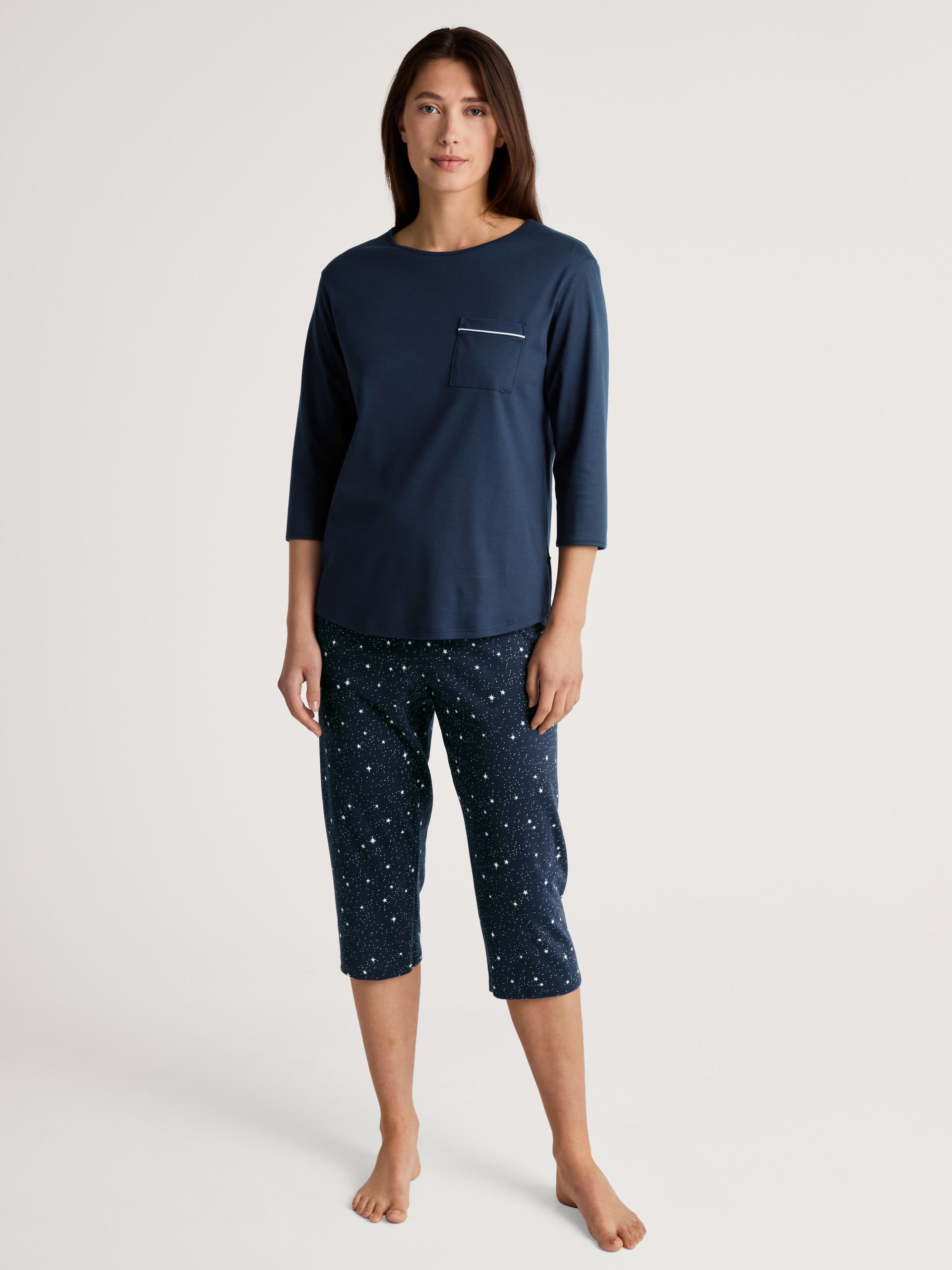Women model is wearing 3/4 pyjama made of 100% Cotton in Blue, Motif from the Sweet Dreams series by CALIDA, Front view