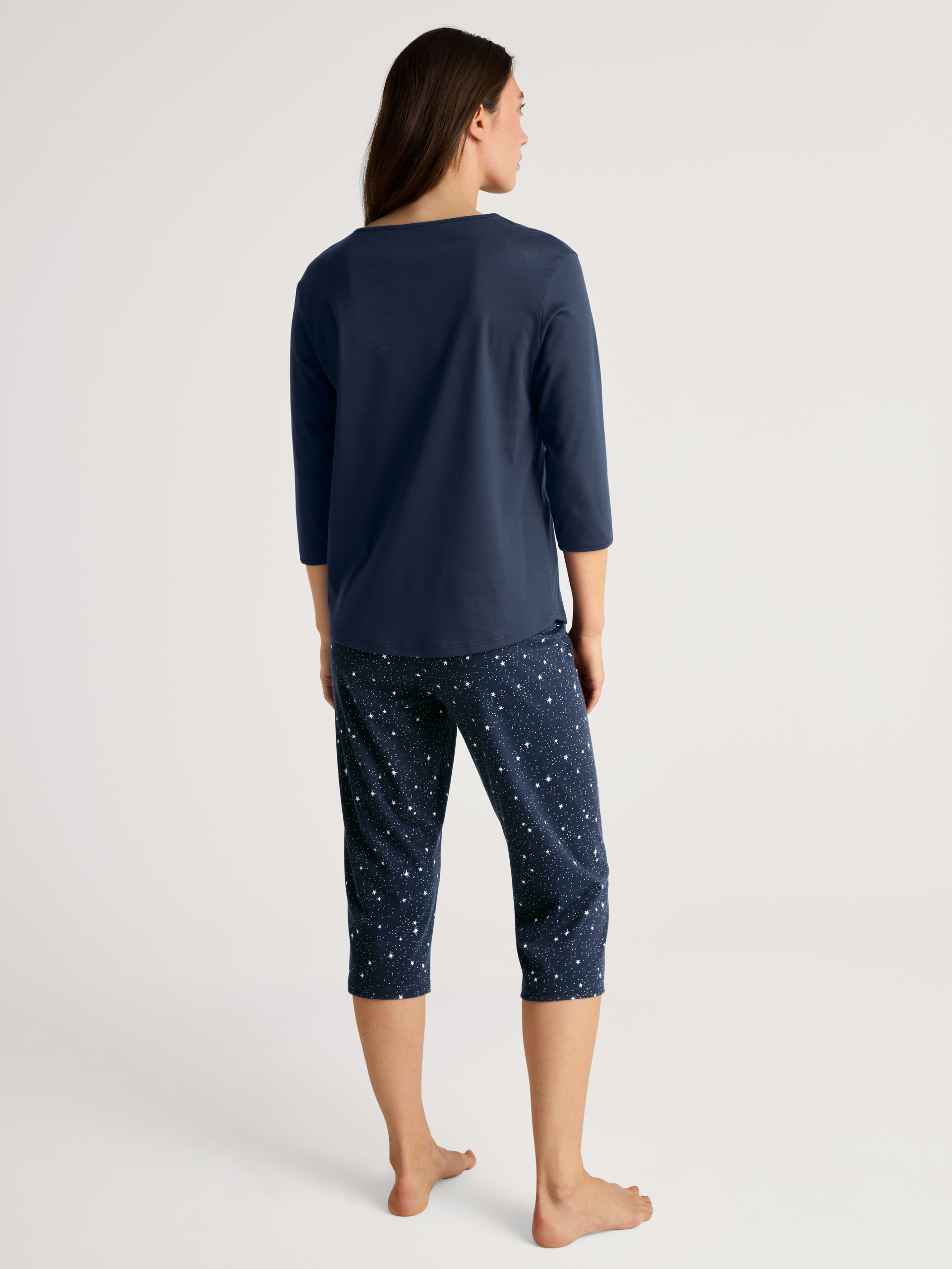 Women model is wearing 3/4 pyjama made of 100% Cotton in Blue, Motif from the Sweet Dreams series by CALIDA, Back view