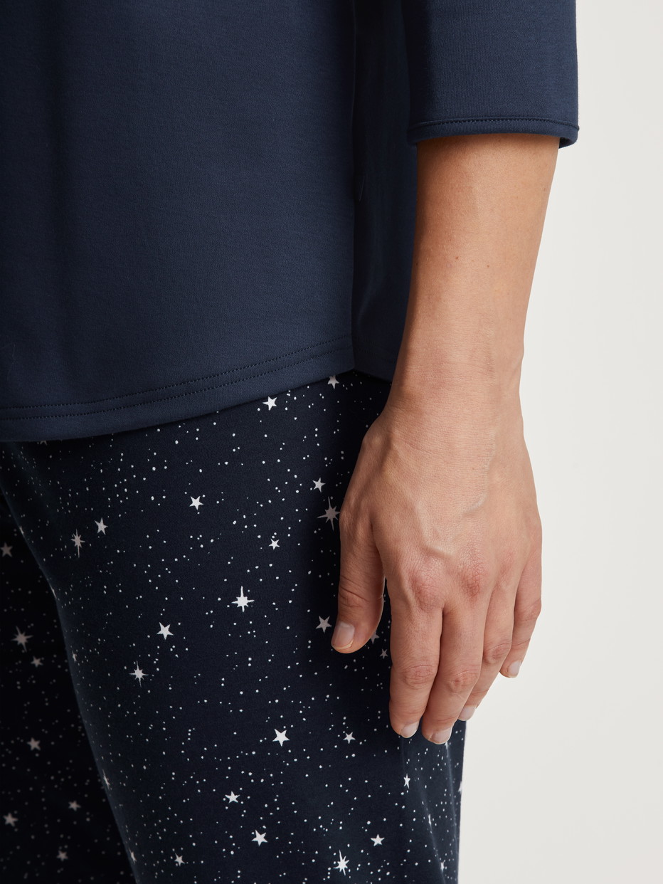 Women model is wearing 3/4 pyjama made of 100% Cotton in Blue, Motif from the Sweet Dreams series by CALIDA, Detail