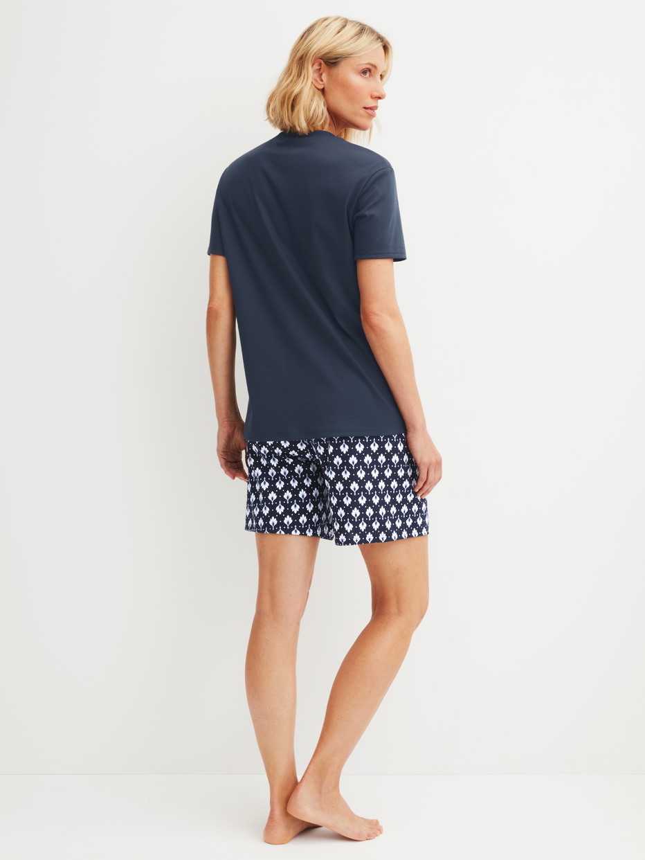 Women model is wearing Short pyjama made of 100% Cotton in Blue, Patterned from the Daylight Dreams series by CALIDA, Back view