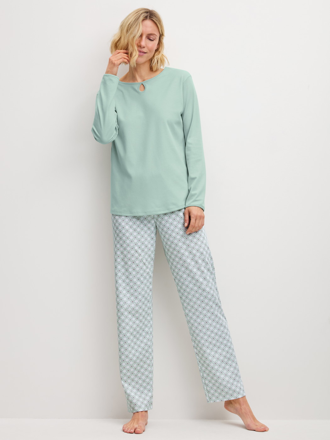 Women model is wearing Pyjamas, long made of 100% Cotton in Turquoise, Patterned from the Sweet Dreams series by CALIDA, Front view