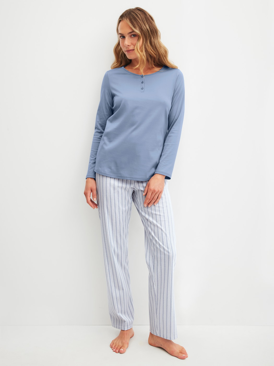 Women model is wearing Pyjamas, long made of 100% Cotton in Blue, Striped from the Striped Dreams series by CALIDA, Front view
