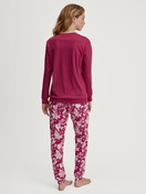 Women model is wearing Pyjama with cuff made of 100% Cotton in Purple, Floral from the Sweet Dreams series by CALIDA, Back view