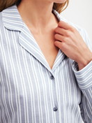 Women model is wearing Button-Up Pyjama made of 100% Cotton in Blue, Striped from the Striped Dreams series by CALIDA, Detail