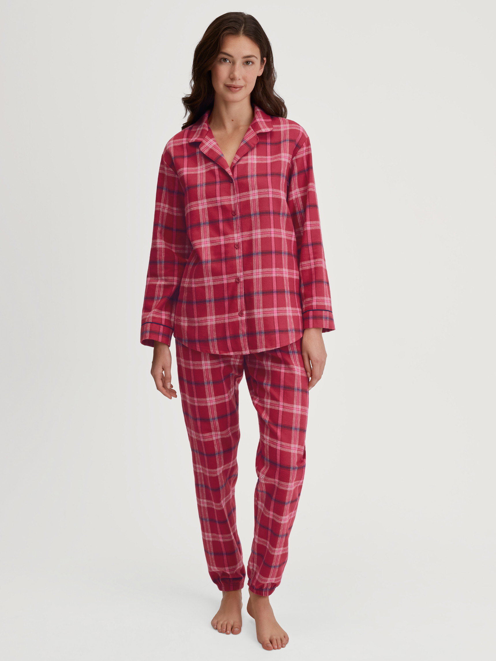 Women model is wearing Flannel pyjamas, buttoned made of 100% Cotton in Red, Checked from the Holiday Dreams series by CALIDA, Front view