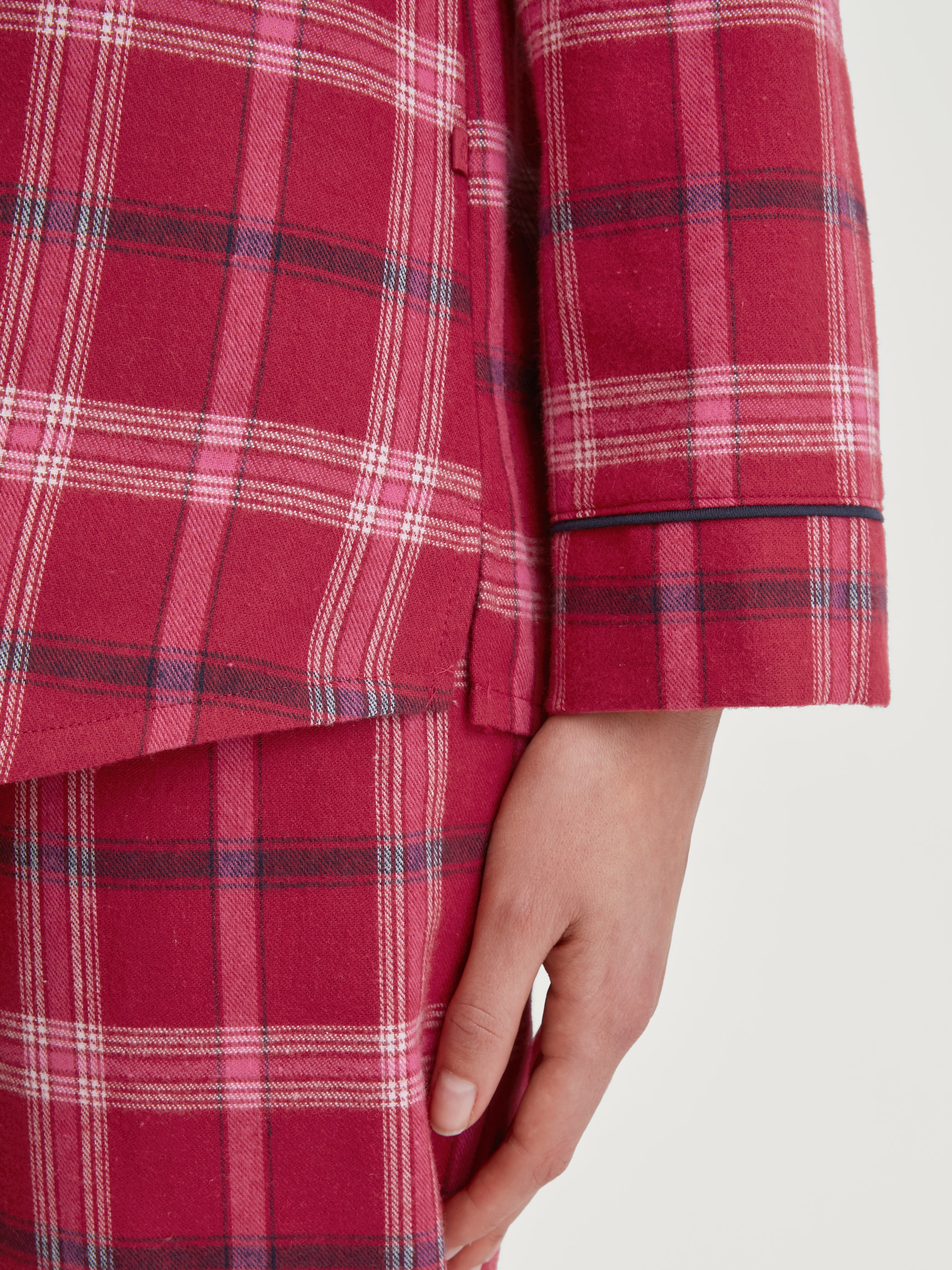 Women model is wearing Flannel pyjamas, buttoned made of 100% Cotton in Red, Checked from the Holiday Dreams series by CALIDA, Detail