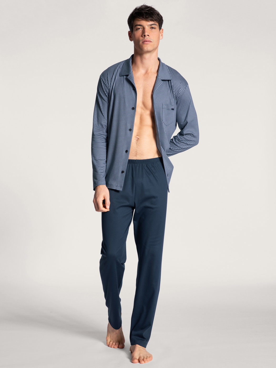 Men model is wearing Pyjama buttoned made of 100% Cotton in Blue, Checked from the Relax Choice series by CALIDA, Front view