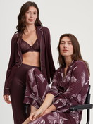 Women model is wearing Button-through pyjamas made from TENCEL™ modal and silk made of Modal in Red, Floral from the Moonlight Dreams series by CALIDA, Additional Image