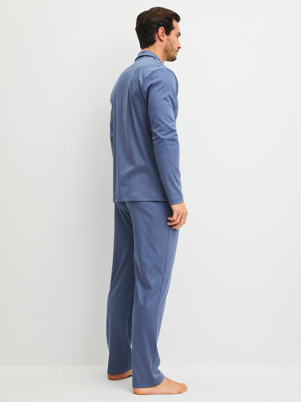 Men model is wearing Pyjamas with buttons made of 100% Cotton in Blue, Unicoloured from the Relax Choice 1 series by CALIDA, Back view
