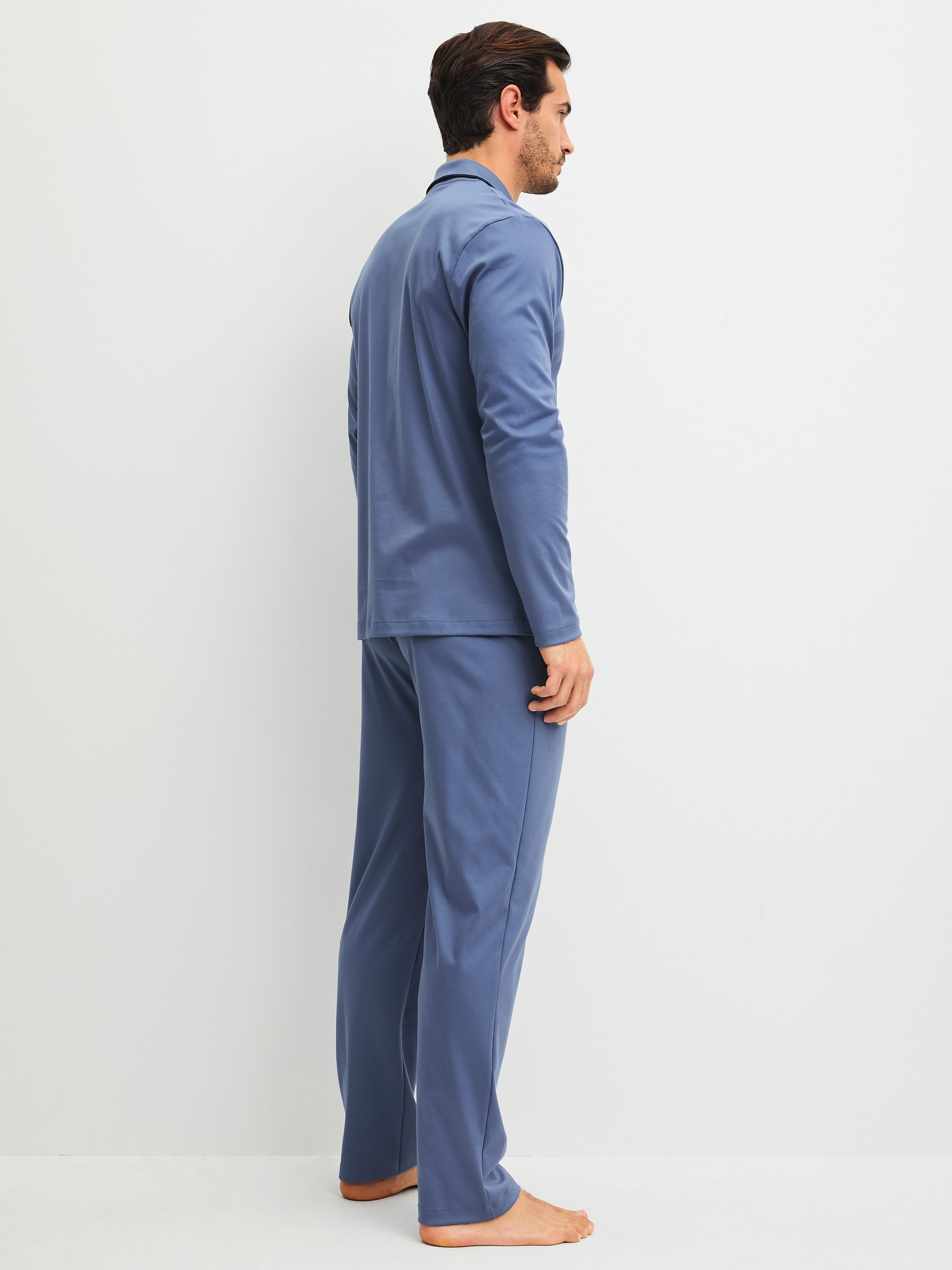 Men model is wearing Pyjamas with buttons made of 100% Cotton in Blue, Unicoloured from the Relax Choice 1 series by CALIDA, Back view