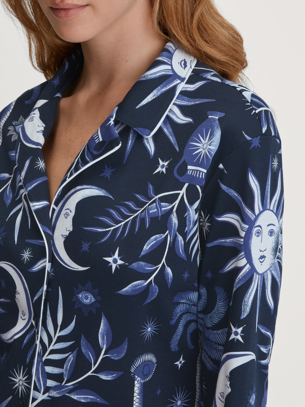 Women model is wearing Button-Up Pyjama made of 100% Cotton in Blue, Patterned from the Winter Dreams series by CALIDA, Detail