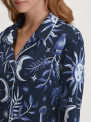 Women model is wearing Button-Up Pyjama made of 100% Cotton in Blue, Patterned from the Winter Dreams series by CALIDA, Detail