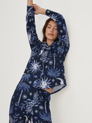 Women model is wearing Button-Up Pyjama made of 100% Cotton in Blue, Patterned from the Winter Dreams series by CALIDA, Front view