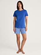 Women model is wearing Short pyjama made of 100% Cotton in Blue, Patterned from the Shell Nights series by CALIDA, Front view