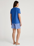 Women model is wearing Short pyjama made of 100% Cotton in Blue, Patterned from the Shell Nights series by CALIDA, Back view